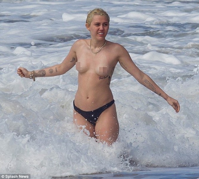 Miley Cyrus topless in the ocean with boyfriend Patrick Schwarzenegger 